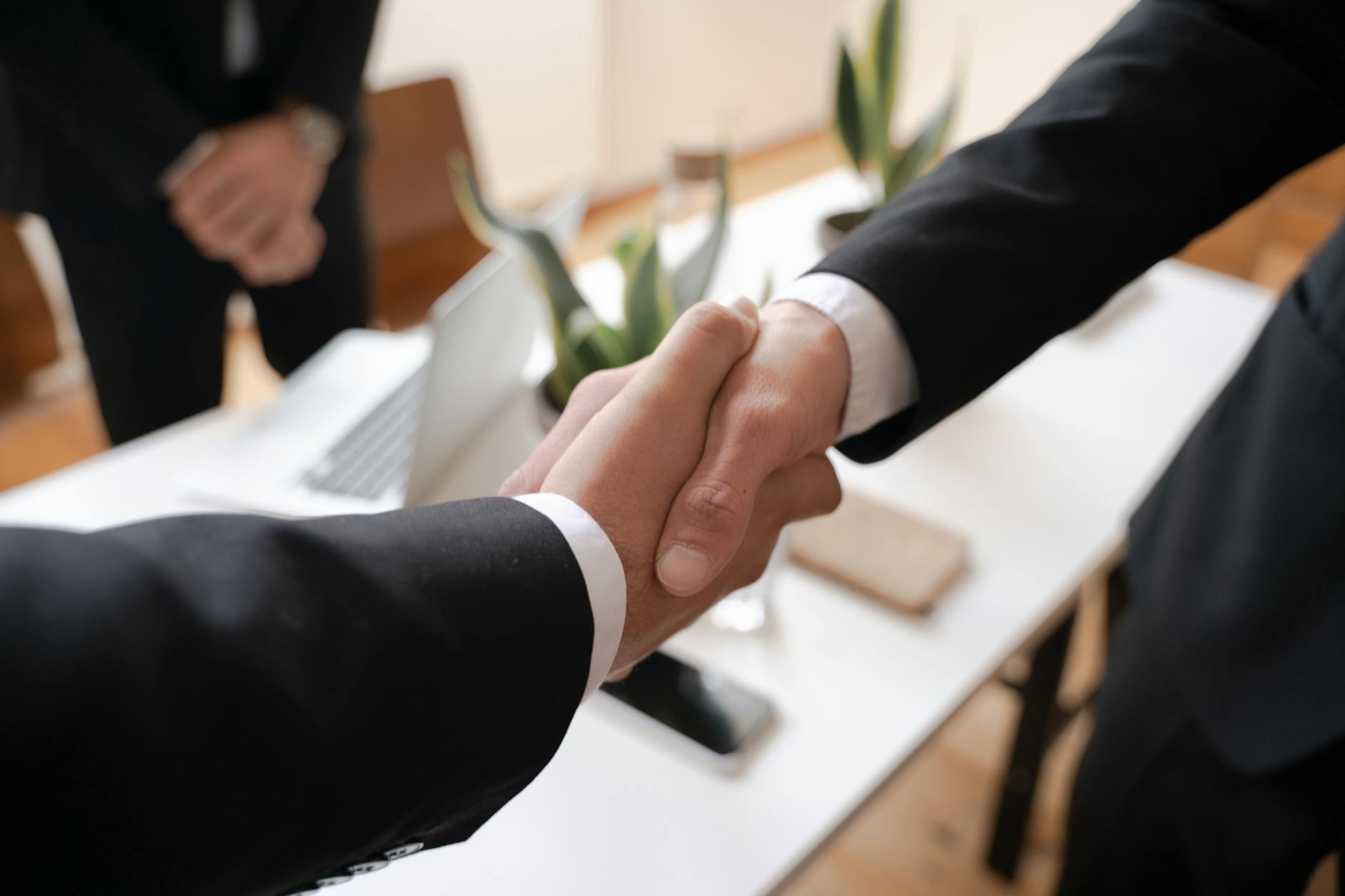 shallow focus of two people handshaking